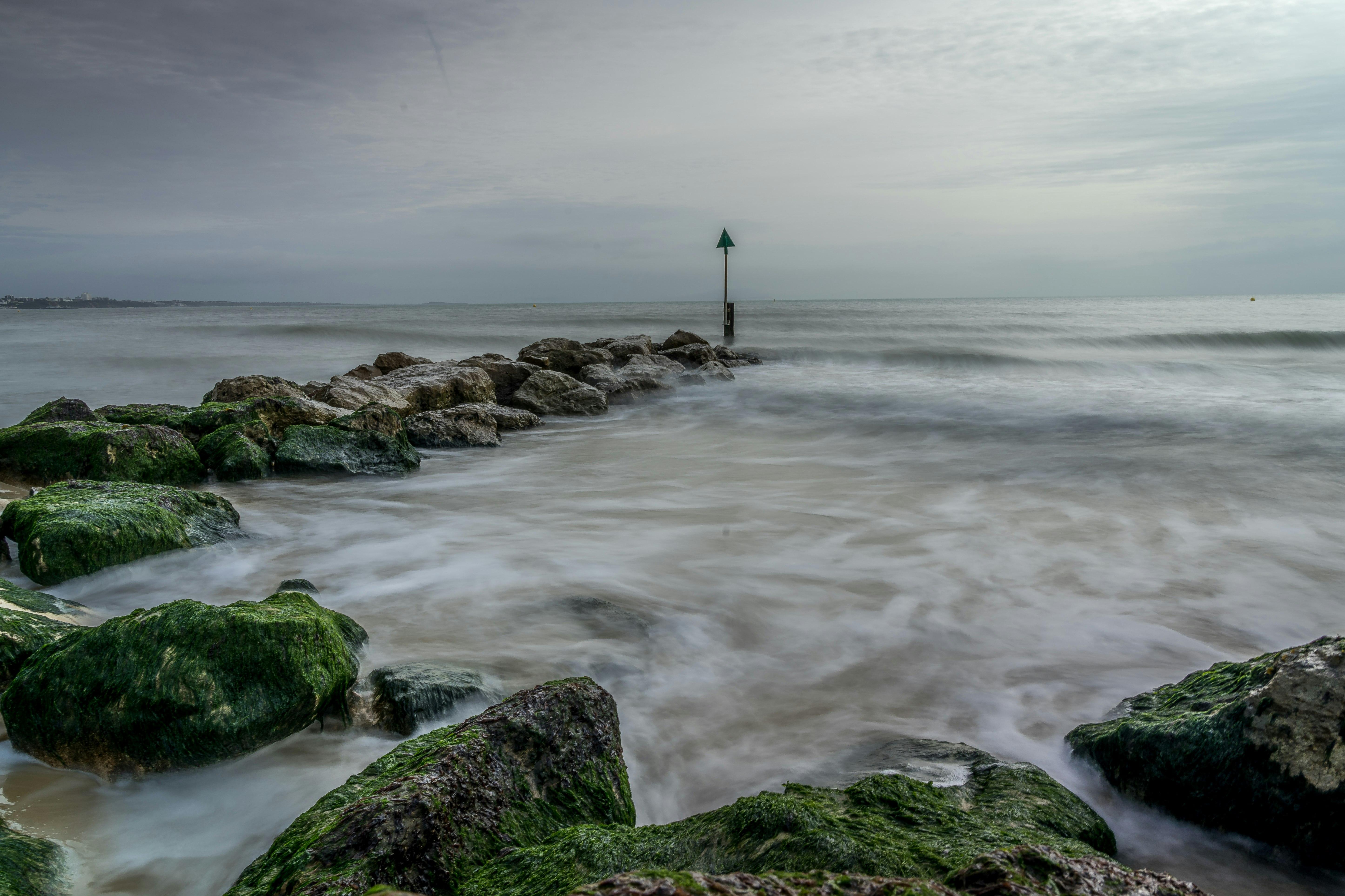 person standing on rock near sea during daytime